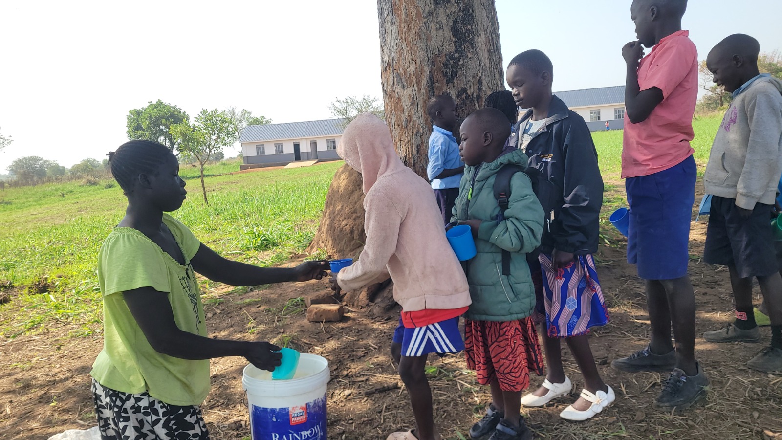 A handwashing station under a tree on the Hope Bridge campus — one of the school's Ebola-response points