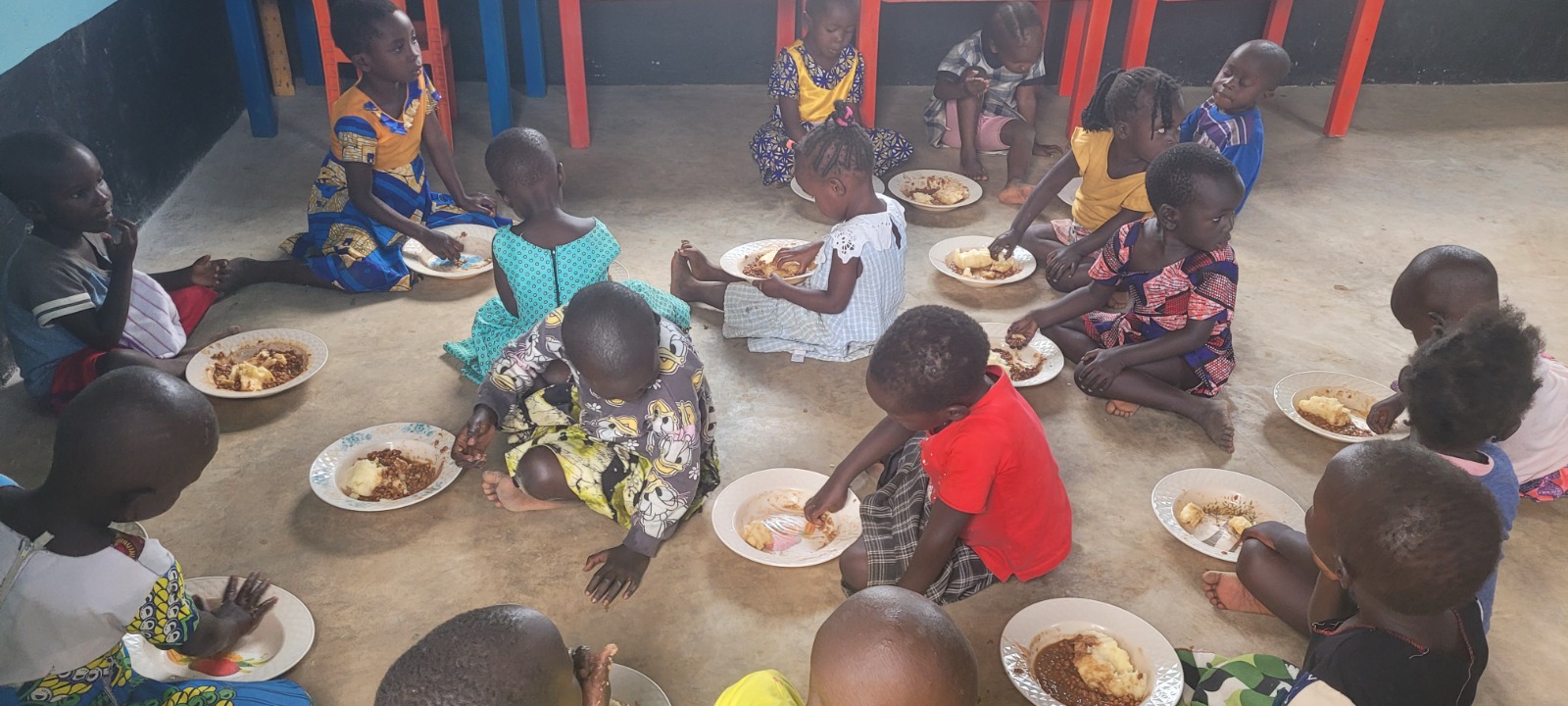 Nursery kids at Hope Bridge eating school lunch together
