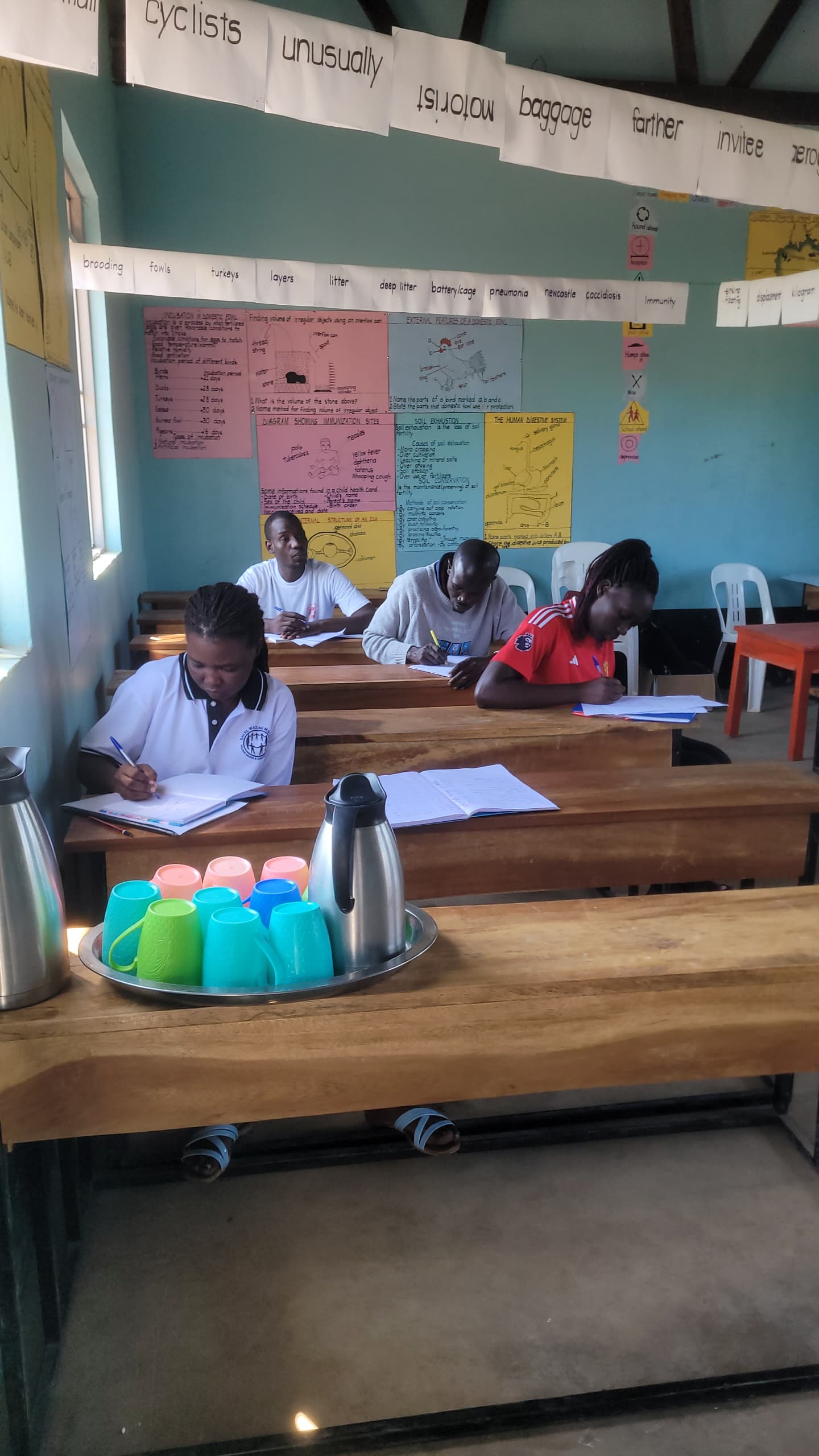 Adult learners at desks in the vocational training classroom